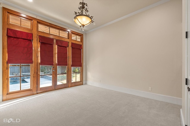 carpeted empty room with french doors and crown molding