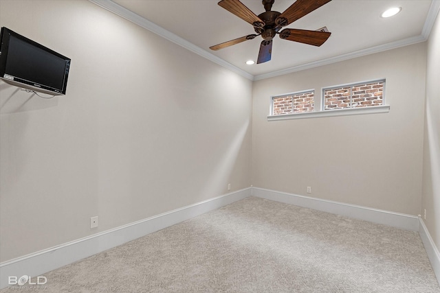 carpeted empty room with ceiling fan and crown molding