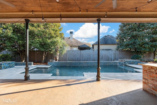 view of swimming pool featuring pool water feature, a patio area, and ceiling fan