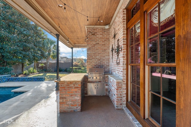 view of patio with a swimming pool and area for grilling