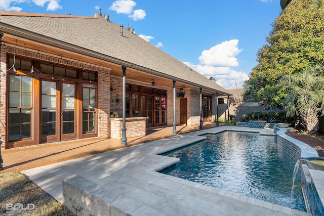 view of pool with pool water feature and a patio area