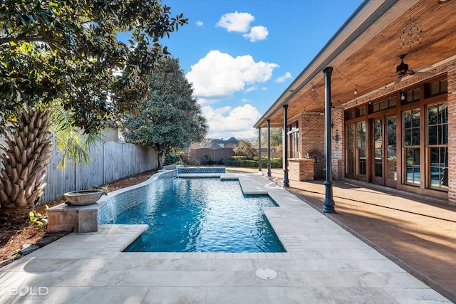 view of pool with ceiling fan, a patio area, and pool water feature