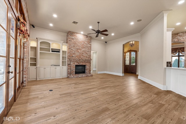 unfurnished living room featuring french doors, a fireplace, and a wealth of natural light