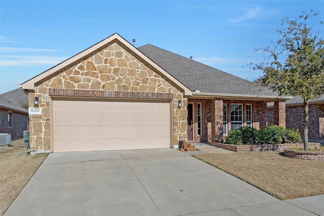 view of front of home featuring central AC and a garage