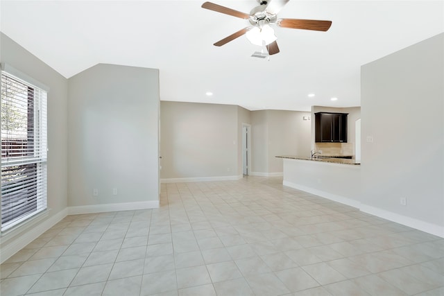 unfurnished living room featuring ceiling fan and light tile patterned floors