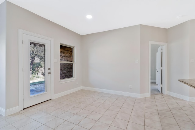 spare room featuring light tile patterned flooring