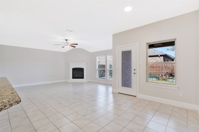 unfurnished living room featuring ceiling fan, light tile patterned flooring, and lofted ceiling