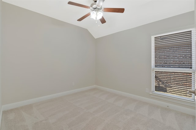 empty room featuring light carpet, ceiling fan, and lofted ceiling