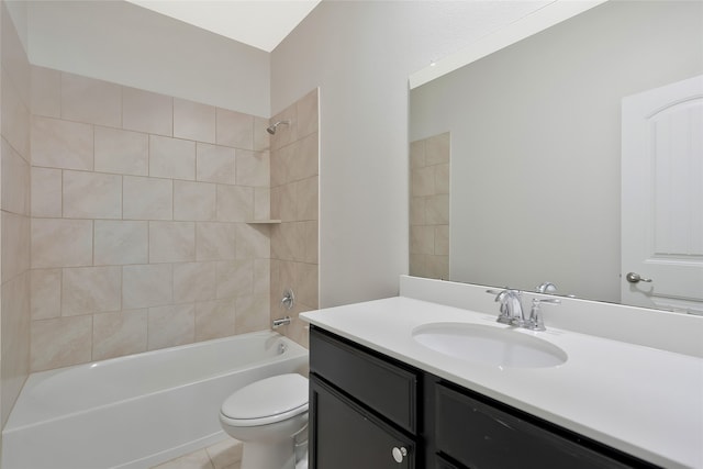 full bathroom featuring tile patterned floors, tiled shower / bath combo, vanity, and toilet