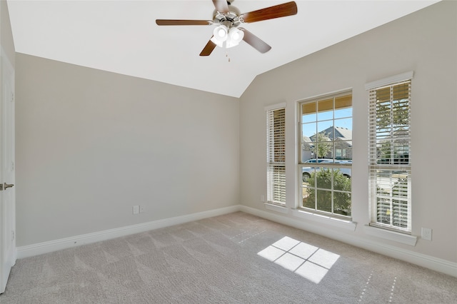 carpeted empty room featuring ceiling fan and vaulted ceiling