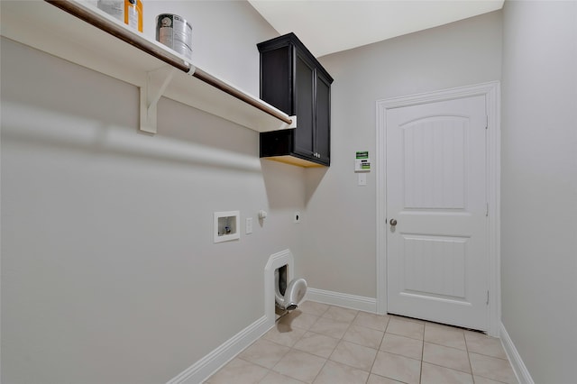 clothes washing area featuring light tile patterned floors, electric dryer hookup, washer hookup, cabinets, and gas dryer hookup