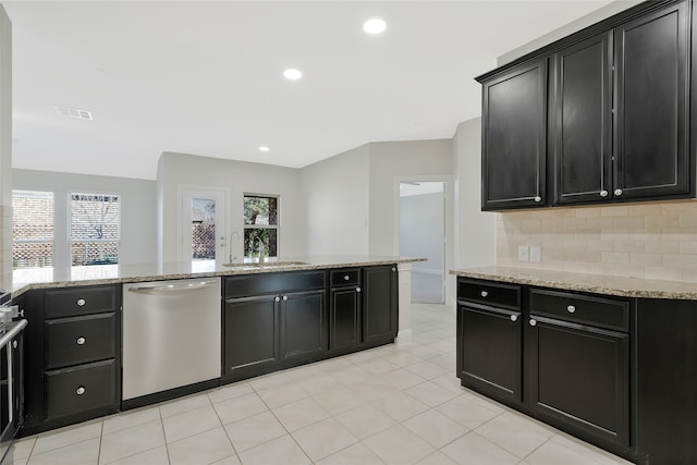 kitchen with dishwasher, plenty of natural light, tasteful backsplash, and sink