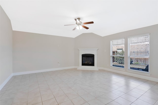 unfurnished living room featuring ceiling fan, light tile patterned flooring, and vaulted ceiling