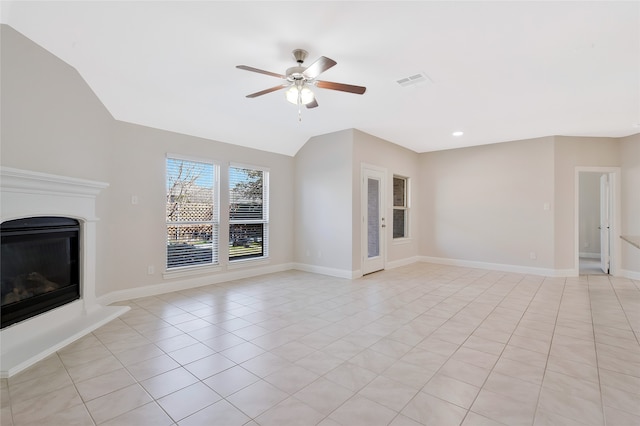 unfurnished living room featuring ceiling fan, light tile patterned floors, and vaulted ceiling