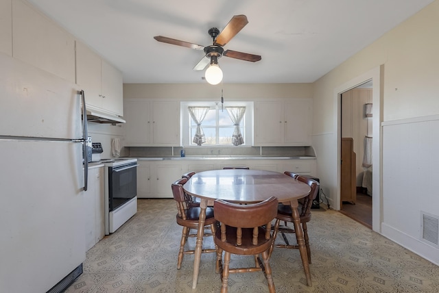 kitchen featuring ceiling fan, white cabinets, and white appliances