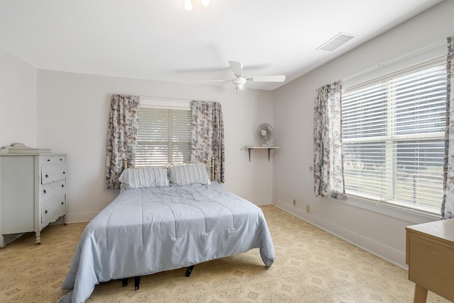 bedroom featuring ceiling fan and multiple windows