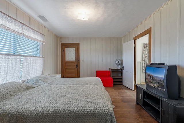 bedroom with dark hardwood / wood-style flooring