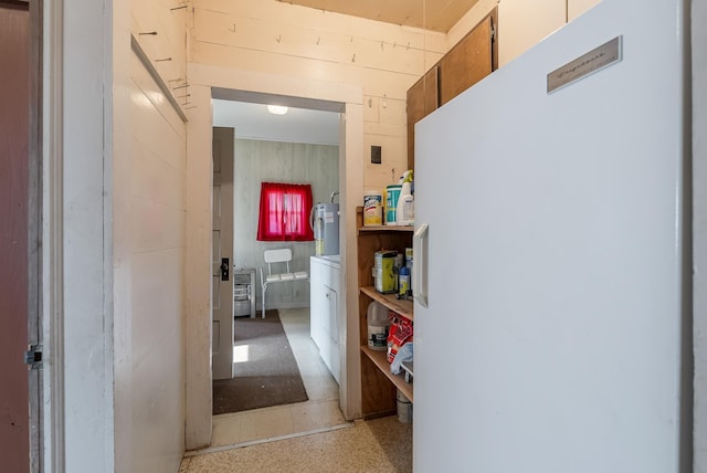 corridor featuring wood walls