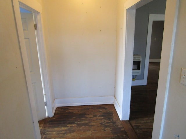 hallway with heating unit and dark hardwood / wood-style flooring