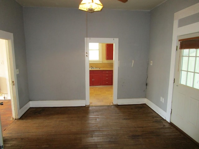 spare room with ceiling fan and dark hardwood / wood-style floors