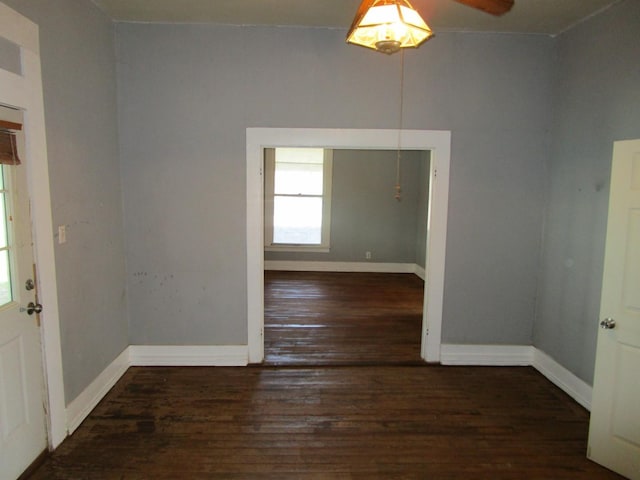 spare room with ceiling fan and dark wood-type flooring