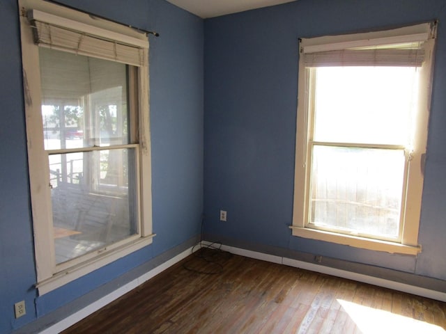 spare room with dark wood-type flooring