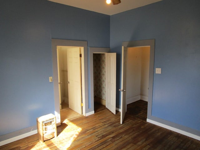 unfurnished bedroom with ceiling fan and dark hardwood / wood-style floors