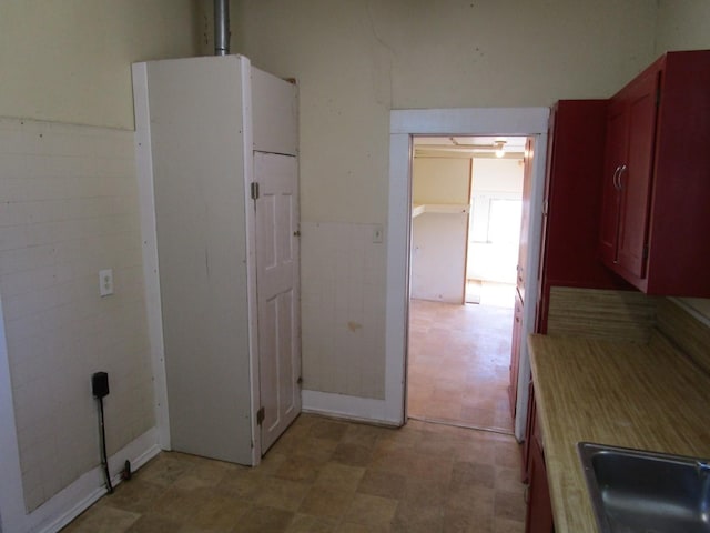 interior space featuring tile walls and sink