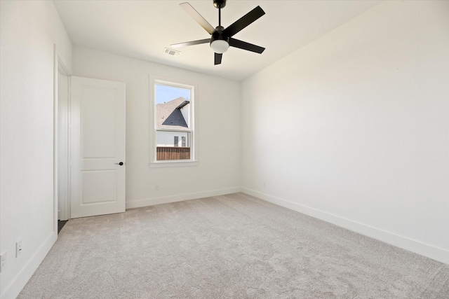 carpeted spare room with ceiling fan