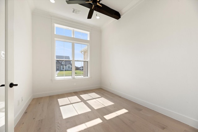 unfurnished room featuring ceiling fan, ornamental molding, beamed ceiling, and light wood-type flooring