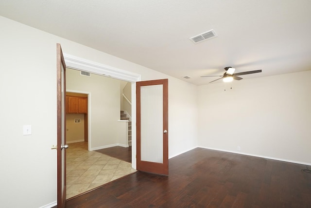 spare room with ceiling fan and wood-type flooring