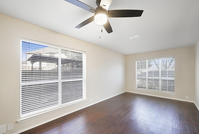 spare room featuring ceiling fan and dark hardwood / wood-style floors