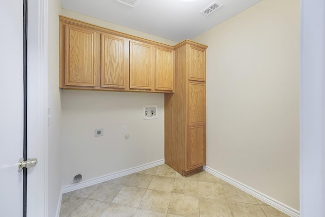 laundry area with hookup for a gas dryer, hookup for an electric dryer, hookup for a washing machine, and cabinets