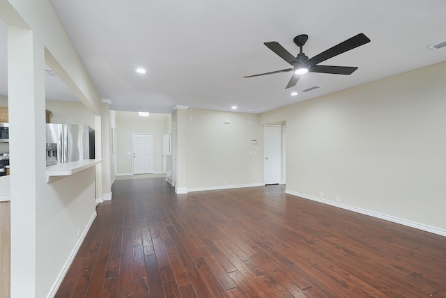 unfurnished living room featuring ceiling fan and dark hardwood / wood-style floors