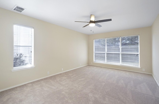 carpeted empty room featuring ceiling fan