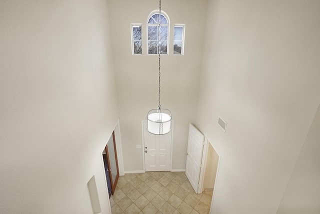 foyer featuring a towering ceiling