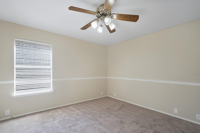 empty room with ceiling fan, light colored carpet, and plenty of natural light