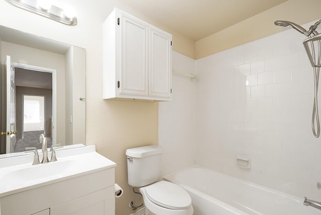 full bathroom featuring toilet, tiled shower / bath combo, and vanity