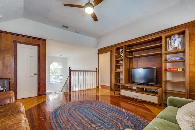 living room with hardwood / wood-style flooring, lofted ceiling, and ceiling fan