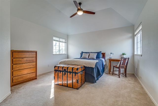 carpeted bedroom featuring ceiling fan and vaulted ceiling