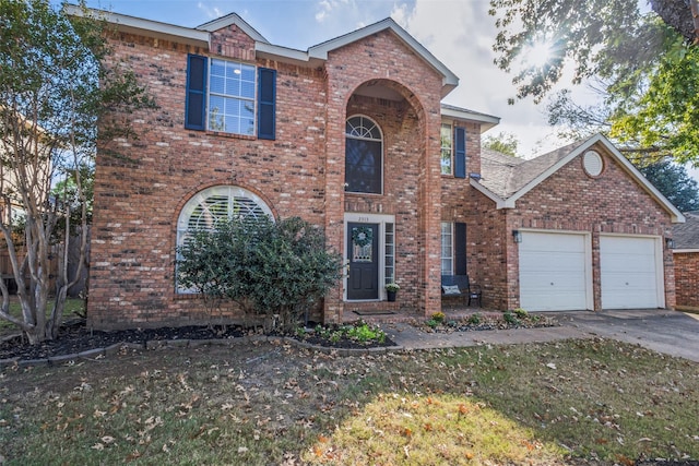 view of front of house featuring a front lawn and a garage