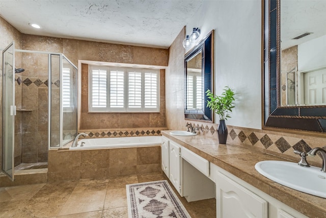 bathroom featuring vanity and independent shower and bath