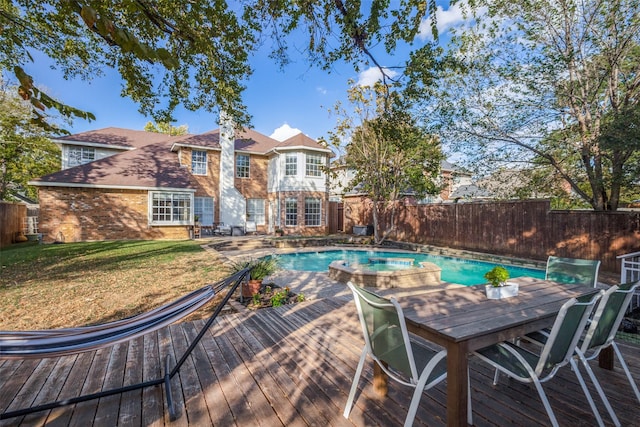 view of swimming pool with a deck and a lawn