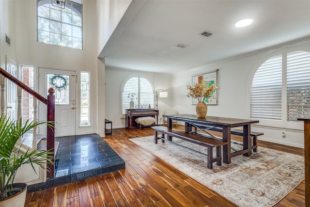 entryway with dark hardwood / wood-style floors and ornamental molding