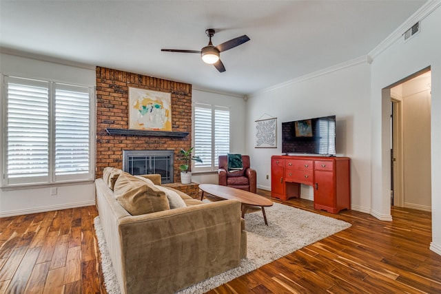 living room with a fireplace, ceiling fan, dark hardwood / wood-style flooring, and a wealth of natural light