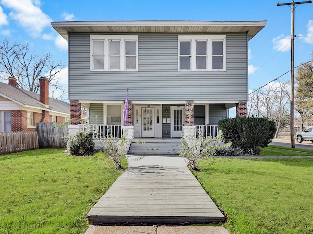 view of front of property featuring covered porch and a front yard