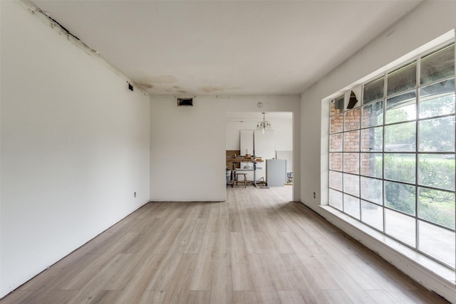 spare room featuring light hardwood / wood-style floors