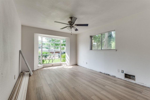 spare room featuring ceiling fan and light hardwood / wood-style flooring