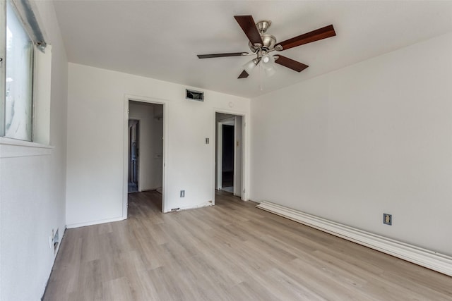 empty room featuring light wood-type flooring and ceiling fan