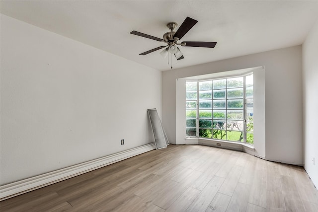 unfurnished room with ceiling fan and light wood-type flooring